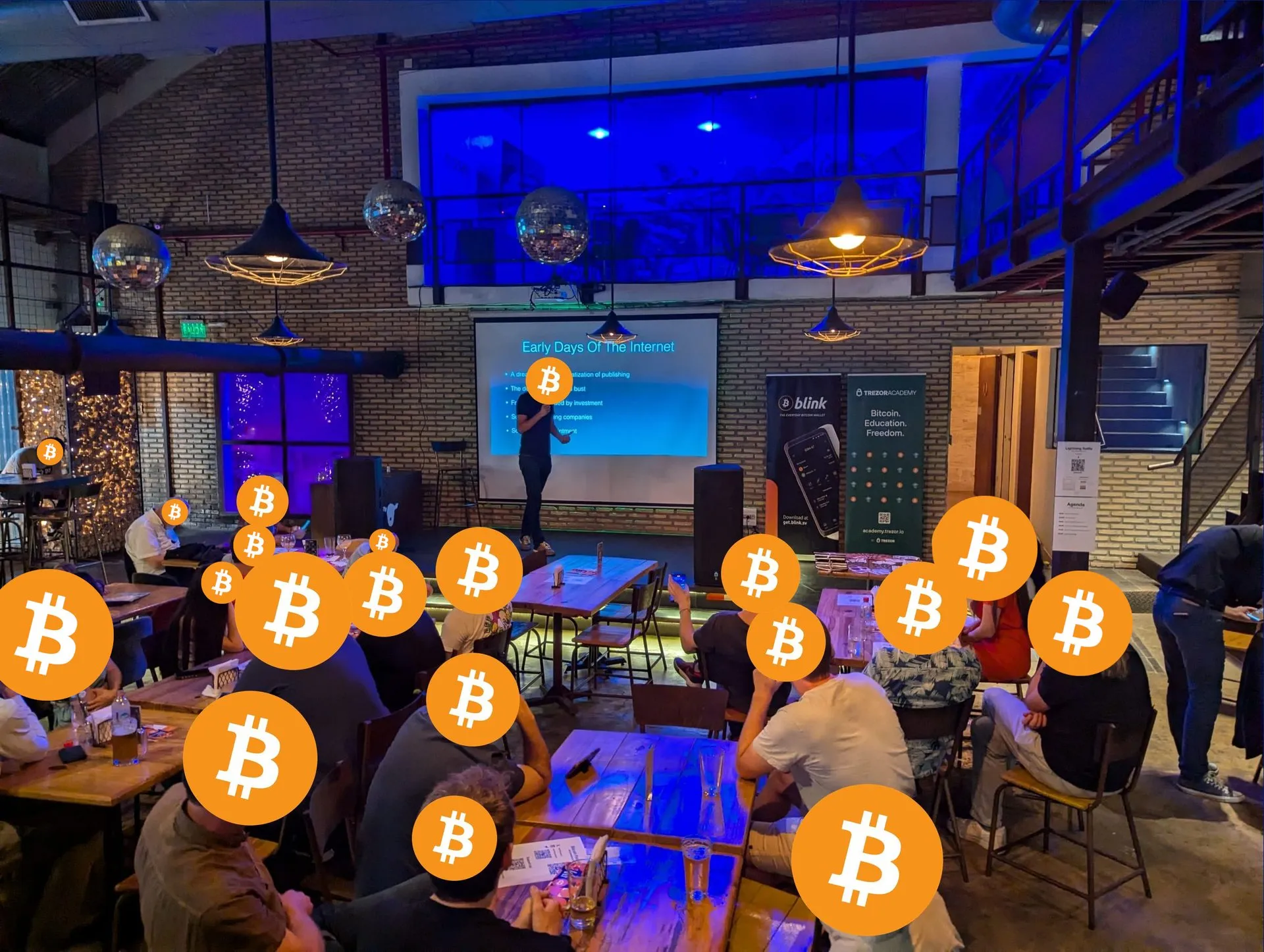 Meetup amplio en un local industrial, con el orador al frente